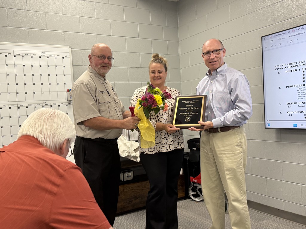 Picture of district teacher of the year and interim superintendent and superintendent
