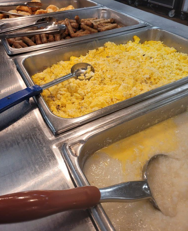 CHS Breakfast Line with grits, eggs, sausage, and biscuits