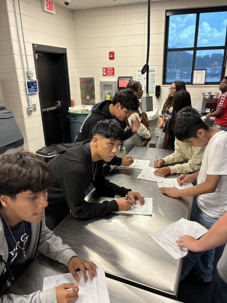 ✨👩‍🍳🔍 Students in Coach McLean’s High School Transitions class stepped into the Culinary Arts department for a hands-on scavenger hunt inside the commercial kitchen!  Working in teams, they explored key stations—hot line, prep, storage, and dishwashing—matched tools to their proper areas, and decoded real menu vocabulary. 🍴📋  Coach McLean shared, “The scavenger hunt helped our students connect career skills with real workplace spaces.”  Culinary Arts Instructor, Mrs. Cindy Hart and her students also showcased professional table settings 🍽️ and reinforced the importance of kitchen safety ✅.  The visit wrapped up with a debrief on teamwork, communication, and professionalism—skills at the heart of the Transitions course. 💡🤝  #HandsOnLearning #CulinaryArts #CareerReady #Teamwork #Communication #Professionalism #EvansCountySchools #TheDen