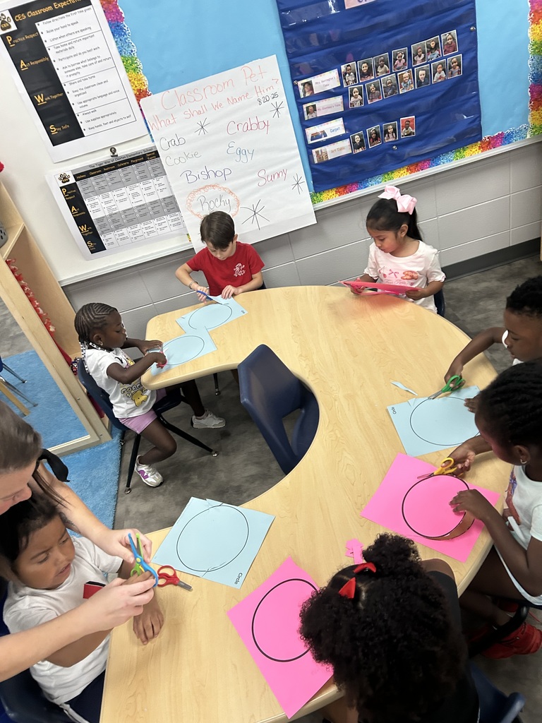 PreK students cutting shapes