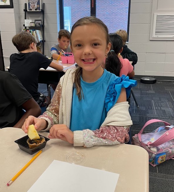 3rd grader enjoying apples and caramel