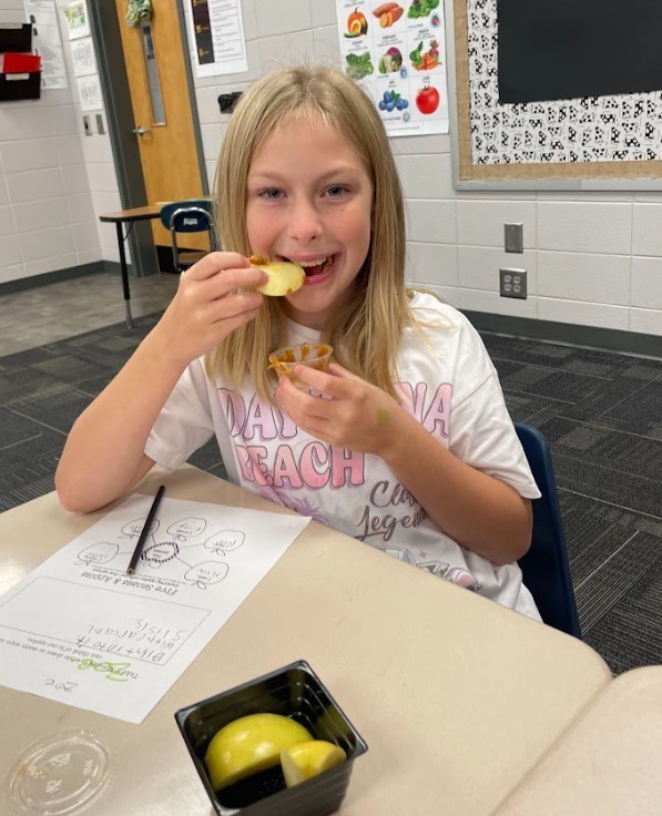 4th grader enjoying apples and caramel