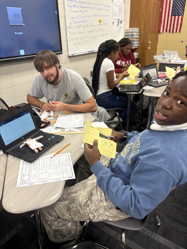 Image showing 📚🤖 In Mrs. Selph’s and Mrs. Cook’s College Readiness class, we’re taking on CRM.GSR.5.4 — using formulas to calculate the volume and surface area of 3D shapes like spheres, prisms, cylinders, pyramids, and cones. But we’re not just crunching numbers… ✏️➗ We’re building robots out of 3D shapes 🤖✨ and proving the math behind them through their surface area and volume! 🐅💛🖤 Go Claxton High School Tigers — black and gold pride all the way! 🖤💛🐅 #CHSTigers #BlackAndGold #CollegeReadiness #STEM #3DShapes #MathInAction #FutureReady