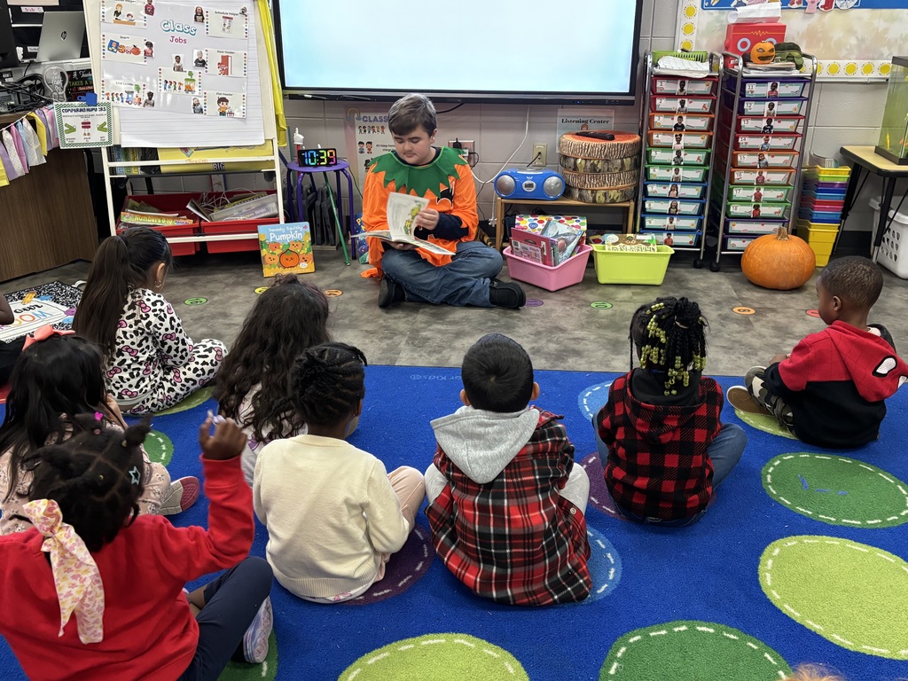 Landon Crosby reads to the students.