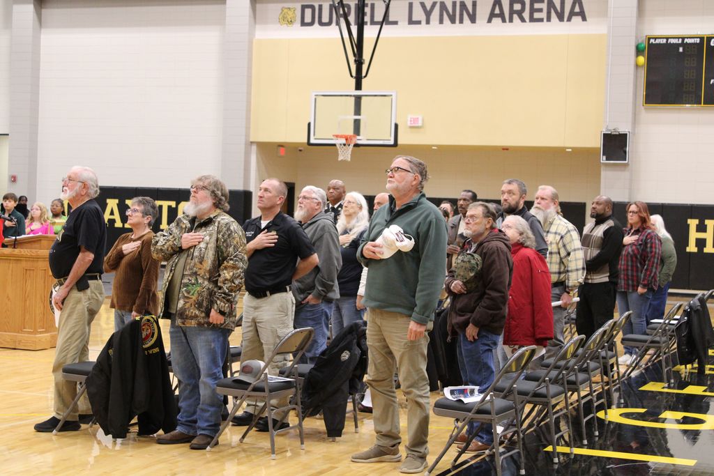Image showing CHS Honors Our Heroes! A Day of Deep Gratitude 🌟 Claxton High School and the history department hosted a deeply meaningful Veterans Day program Tuesday, November 1, 2025, to honor those who have served. 🏫 The day began bright and early with a special breakfast 🥓☕ for the veterans, a small token of our immense appreciation.  Our guest speaker, 2nd Lt. Jordan Hendrix (Platoon Leader, 3rd ID, Ft. Stewart), delivered a powerful message on selfless service 🛡️, emphasizing that true dedication happens not just on the battlefield but also in the quiet moments of daily life. He encouraged our students to live with purpose and "do what is right, even when no one is watching." 💪  The program featured heartfelt tributes from our talented students (Mila Sapp, Emmie Stanfield, Victor Fuentes, Kaydence Snellgrove, Jordan Brown) and inspiring performances by the CHS Band 🎶🎺 and Chorus 🎤. The ceremony culminated with the band’s moving Salute to Armed Forces, where we proudly recognized the veterans from each service branch present with a big round of applause! 👏  Thank you to all our veterans for your service and sacrifice! 🙏 Your commitment inspires us all. 💖  #CHSVeteransDay #ThankYouVets #SelflessService #ClaxtonHigh #LivingWithPurpose #GAStrong #MilitaryAppreciation #Honor 🦅  Pictures courtesy of Gregory Crosby, Dylan Tidwell, and Glenn Lewis