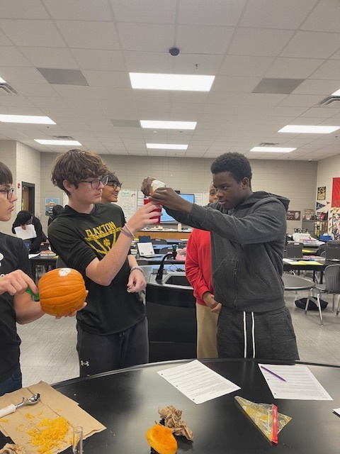Image showing What's inside a pumpkin? Ask Mrs. Minis' Biology class! 🧠 Students spent time exploring the molecular building blocks of life by performing a hands-on lab to extract DNA from pumpkins. This simple yet powerful experiment helped them visualize DNA strands and reinforce their genetics lessons. After their lab, they enjoyed some fun carving time. Excellent job combining learning and celebration! 🖤🧡 #BiologyLab #DNAExtraction #MinisClass #ScienceEducation