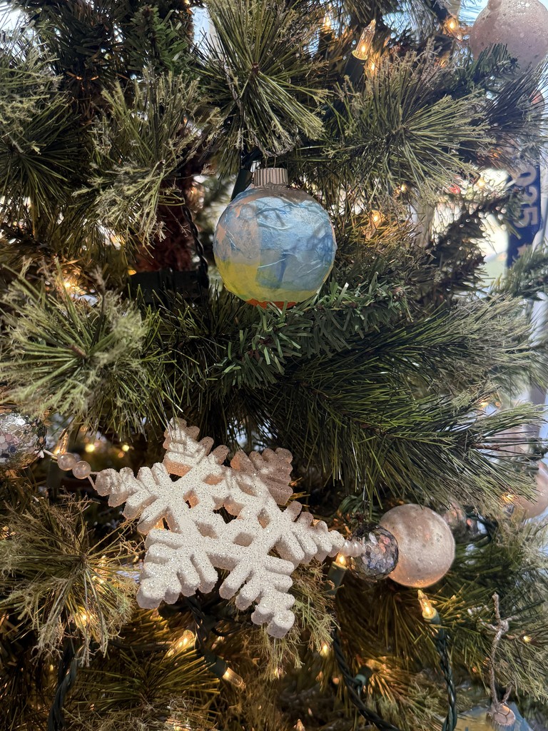 Image showing ✨Please visit the Evans County Downtown Development Authority's Festival of Trees hosted by Claxton City Hall to see the tree decorated with beautiful, custom ornaments made by the dedicated CMS/CHS Special Olympics athletes during the fall games. The Festival of Trees is on display at City Hall through January 2, 2026 during business hours (Mondays- Thursdays 8:15-4:30 and Fridays 8:15-12:00).  #HolidaySeason #AthleteArt #ClaxtonCityHall #FestiveOfTrees 🎄