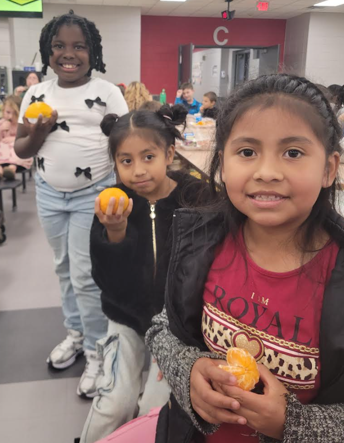 Students holding their citrus fruits.