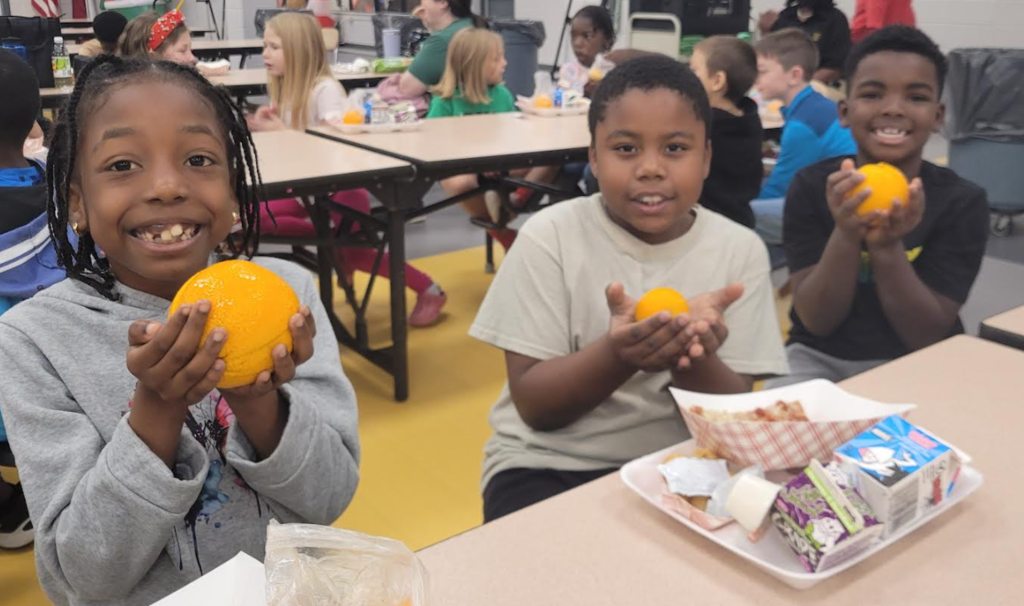Students holding their citrus fruits.
