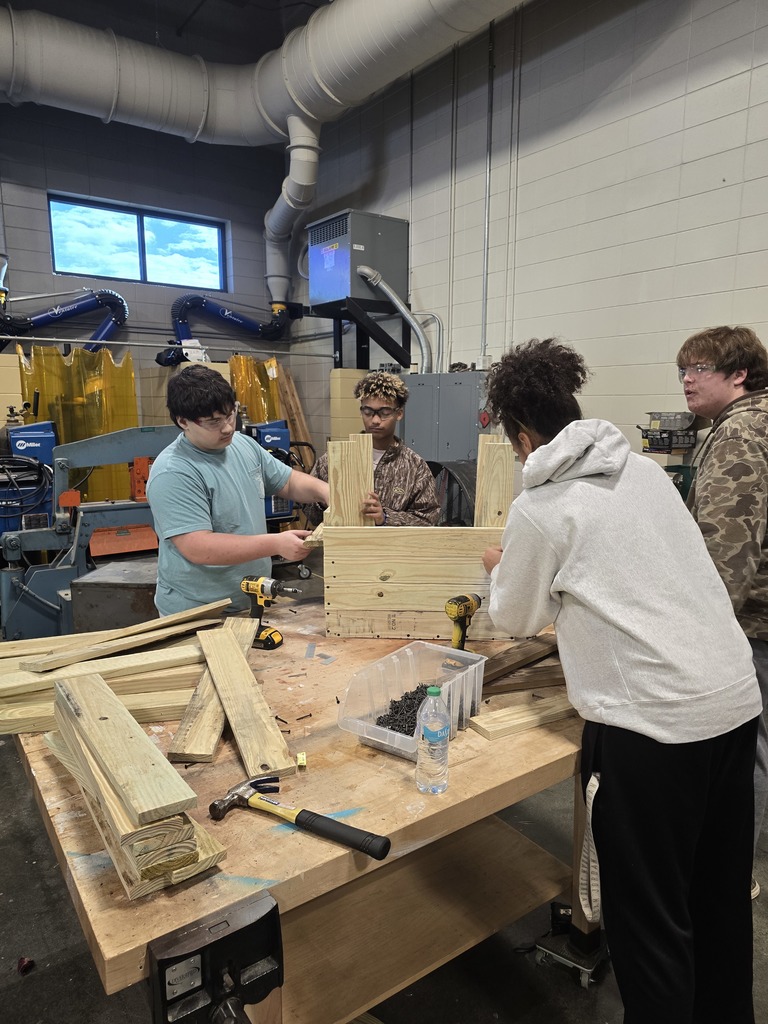 Image showing 🎄 Ag Mech Students Building Holiday Cheer! 🚂 Mr. Turner's Ag Mech 1 class students are hard at work, applying their skills to build a special wooden train for Christmas!  This project is a great way for students to master essential skills, including woodworking techniques, effective communication for collaboration, and the importance of using proper PPE (Personal Protective Equipment) to ensure safety.  Great job blending craftsmanship with holiday spirit! 🖤💛  #TheDEN #AgMech1 #Woodworking #CTAE #ShopClass #ChristmasProject #SafetyFirst 🛠️
