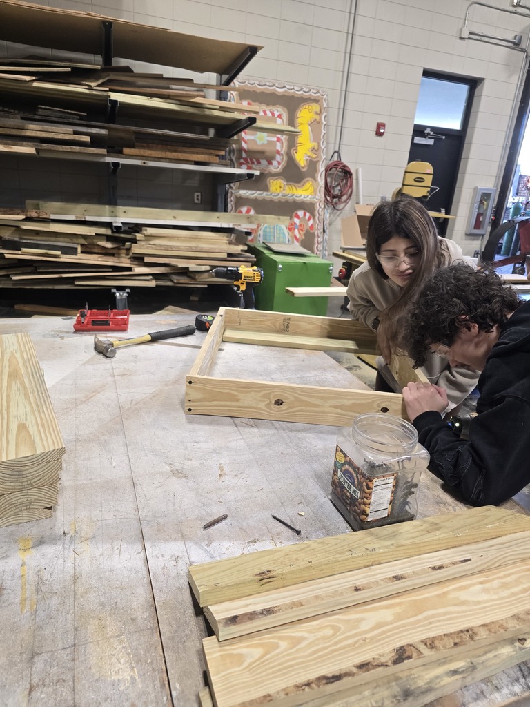 Image showing 🎄 Ag Mech Students Building Holiday Cheer! 🚂 Mr. Turner's Ag Mech 1 class students are hard at work, applying their skills to build a special wooden train for Christmas!  This project is a great way for students to master essential skills, including woodworking techniques, effective communication for collaboration, and the importance of using proper PPE (Personal Protective Equipment) to ensure safety.  Great job blending craftsmanship with holiday spirit! 🖤💛  #TheDEN #AgMech1 #Woodworking #CTAE #ShopClass #ChristmasProject #SafetyFirst 🛠️