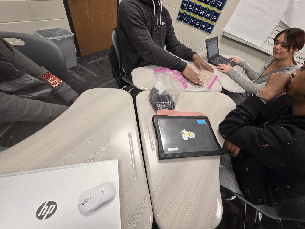 Image showing 🧟‍♂️ Modeling the "Zombie Apocalypse" in Advanced Algebra! 📊  Is it a movie set? No, it's math class! Coach Transue’s Advanced Algebra students are currently mastering exponential functions by simulating a zombie virus outbreak.  Using a population simulation with different markers, students tracked how a single "infection" can spread through a crowd. By shaking the population bags and recording how many new "zombies" appeared in each round, students were able to visualize:  Exponential Growth: How quickly a virus can spread through a healthy population.  Exponential Decay: The rapid reduction of the healthy population over time.  It was a fantastic, hands-on way to turn abstract equations into real-world (and fictional-world!) data. Great job, Tigers! 🖤💛  #AdvancedAlgebra #ExponentialGrowth #MathSimulation #HandsOnLearning