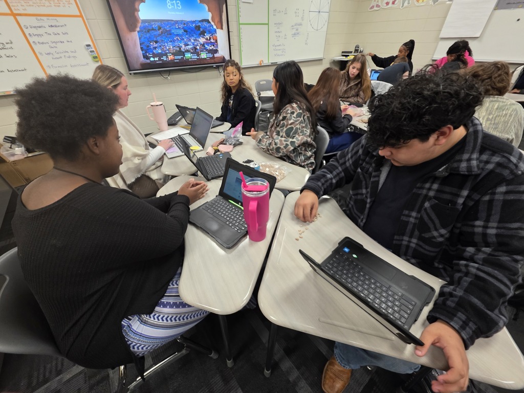 Image showing 🧟‍♂️ Modeling the "Zombie Apocalypse" in Advanced Algebra! 📊  Is it a movie set? No, it's math class! Coach Transue’s Advanced Algebra students are currently mastering exponential functions by simulating a zombie virus outbreak.  Using a population simulation with different markers, students tracked how a single "infection" can spread through a crowd. By shaking the population bags and recording how many new "zombies" appeared in each round, students were able to visualize:  Exponential Growth: How quickly a virus can spread through a healthy population.  Exponential Decay: The rapid reduction of the healthy population over time.  It was a fantastic, hands-on way to turn abstract equations into real-world (and fictional-world!) data. Great job, Tigers! 🖤💛  #AdvancedAlgebra #ExponentialGrowth #MathSimulation #HandsOnLearning