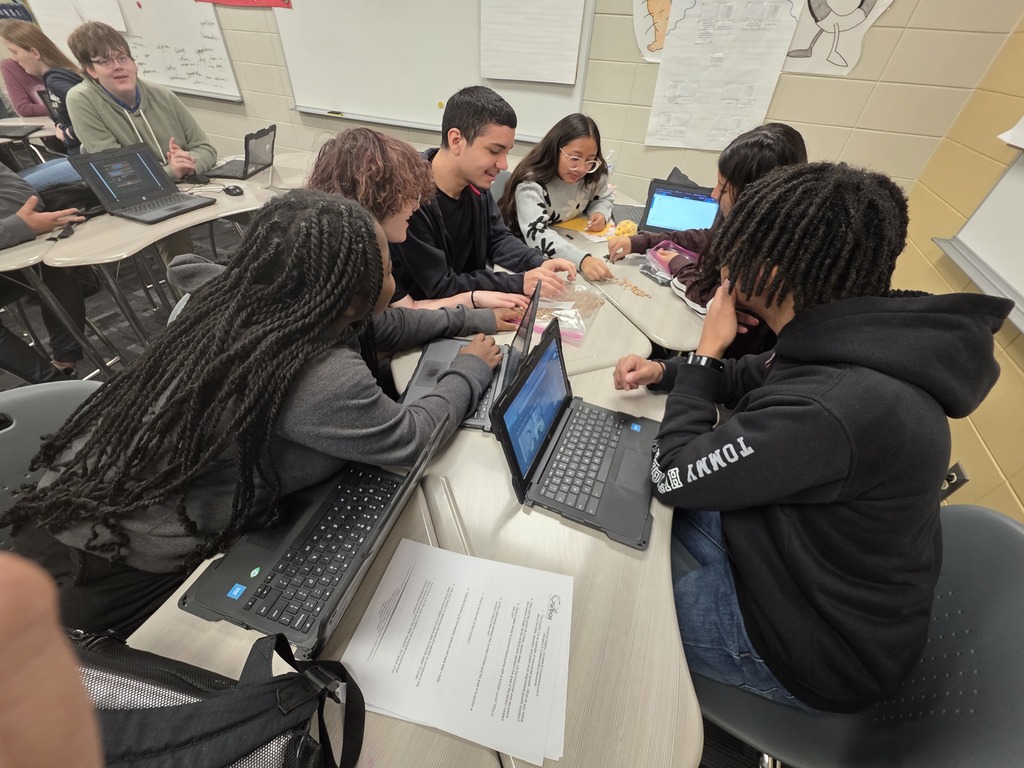 Image showing 🧟‍♂️ Modeling the "Zombie Apocalypse" in Advanced Algebra! 📊  Is it a movie set? No, it's math class! Coach Transue’s Advanced Algebra students are currently mastering exponential functions by simulating a zombie virus outbreak.  Using a population simulation with different markers, students tracked how a single "infection" can spread through a crowd. By shaking the population bags and recording how many new "zombies" appeared in each round, students were able to visualize:  Exponential Growth: How quickly a virus can spread through a healthy population.  Exponential Decay: The rapid reduction of the healthy population over time.  It was a fantastic, hands-on way to turn abstract equations into real-world (and fictional-world!) data. Great job, Tigers! 🖤💛  #AdvancedAlgebra #ExponentialGrowth #MathSimulation #HandsOnLearning
