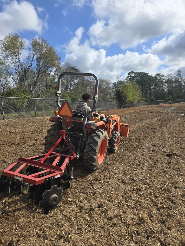 Image showing 🚜 Breaking Ground: Ag Mech 2 is Heading to the Field! 🌱  Spring is just around the corner, and our Ag Mechanics 2 students are making sure The DEN is ready! This week, students moved from the classroom to the tractor seat to begin prepping the soil for our springtime grass planting.  This hands-on lesson focused on the mastery of the three-point harrow. Operating a tractor while pulling an implement requires a high level of coordination and a "safety-first" mindset. Our Tigers aren't just driving; they are learning the technical side of agriculture, including:  Safe Operating Procedures: Mastering the "rules of the road" for agricultural machinery.  Hitch Mastery: Identifying tractor parts and the complex mechanics of attaching and removing implements.  Precision Prep: Using the harrow to break ground effectively for optimal planting conditions.  We are proud to see our students applying their classroom knowledge to real-world tasks! 🐯🖤💛  #TheDEN #AgMechanics #HandsOnLearning #FutureFarmers #TractorSafety #ClaxtonHigh