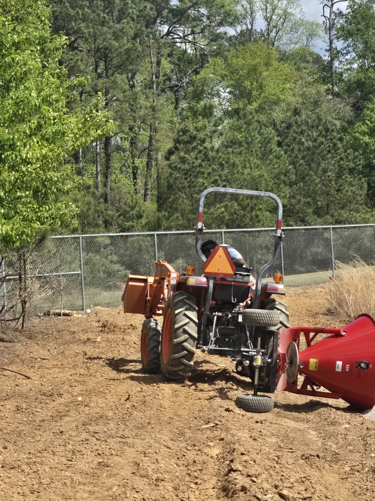 Image showing 🌱 Real-World Lessons in the Garden: Watch Your Step! 🚜 In Mr. Turner’s Horticulture class, we know that the best learning happens outside the four walls of a classroom. Recently, our students were busy spreading seed to get the campus ready for spring—but they picked up a very important lesson in physics along the way! The takeaway: When you’re operating a spreader, you have to keep your eyes on the ground. One hidden hole or a bit of uneven turf is all it takes to flip your equipment and send your seed flying! Don't worry! The seeds were salvaged after the mishap. Ag education is all about trial, error, and adjustment. Our Tigers dusted themselves off, leveled out their path, and got back to work. Experience is the best teacher! 🐯🖤💛 #TheDEN #Horticulture #LearningByDoing #AgLife #WatchTheHoles #TigerPride