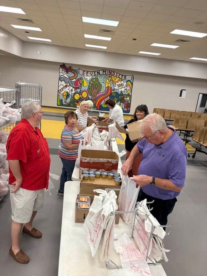 Community volunteers helping pack meals for the summer program. 