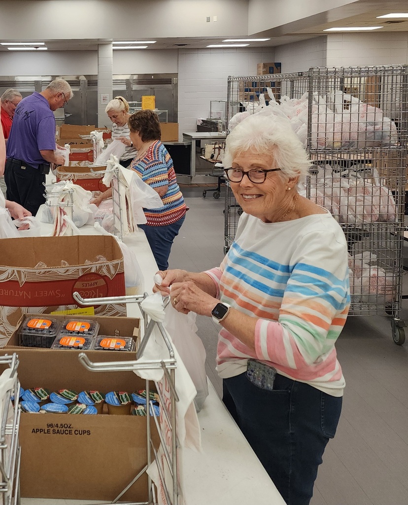 Community volunteers helping pack meals for the summer program. 