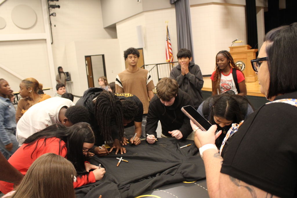 Image showing 🎓✨ CHS FRESHMEN COMMIT TO GRADUATING! CLASS OF 2030 TAKES THE PLEDGE! 🖤💛🐅  On Friday, October 2, 2026, our Claxton High School 9th graders took a monumental step in their high school journey during the annual 9th Grade Commitment Ceremony! Surrounded by families, faculty, and supporters, the Class of 2030 officially pledged to put in the work required to cross the stage and graduate on time in May 2030! 📜🎓  The morning opened with a warm welcome from CHS Principal James Rowe, followed by CHS Counselor Pamela Calloway introducing guest speaker and CHS alumnus Robbie Lane (Class of 2022)! 🎙️🌟  Robbie delivered an inspiring message, sharing 5 key points for achieving success in school and in life: 1️⃣ Set goals and chase goals 🎯 2️⃣ Be a great friend and make great friends 🤝 3️⃣ Build a strong work ethic 💪 4️⃣ Never let anyone tell you that you can't 🚫🛑 5️⃣ Find your purpose ✨  To seal their commitment, students signed a graduation gown, enjoyed refreshments with their families, and took a full class photo to mark this special milestone! 📸🥳  We are so proud of our Class of 2030 and can’t wait to support them every step of the way as they strive with one shared purpose under One Roar! ⚡  Once a Tiger, always a Tiger! 🐅🐾  #OneRoar #ClaxtonTigers #ClassOf2030 #CommitmentCeremony #GraduationBound #FreshmanYear #TigerPride #OnceATigerAlwaysATiger #ClaxtonGA #CHSTigers