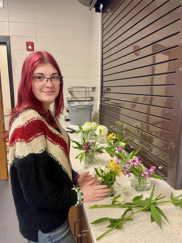 Recently CHS hosted the Annual Claxton-Evans Chamber of Commerce banquet. For this special event, many capable and talented people transformed the high school cafetorium into a lovely dining hall. One of those individuals was senior Lainey Phillips who offered her talent in floral arranging to help create centerpieces for the various tables. In the past months, Lainey’s talent has been linked with experience through her Work-Based Learning placement with The Flower Girl in Statesboro. Her supervisor tells us that Lainey has blossomed in her role at the floral shop, and she has gained experience in every aspect of the business. This foundation has been invaluable for the future Lainey has planned in floristry! CHS can’t wait to see how your career unfolds. We are so proud of you! #TheDEN #TigersBuildingSuccess