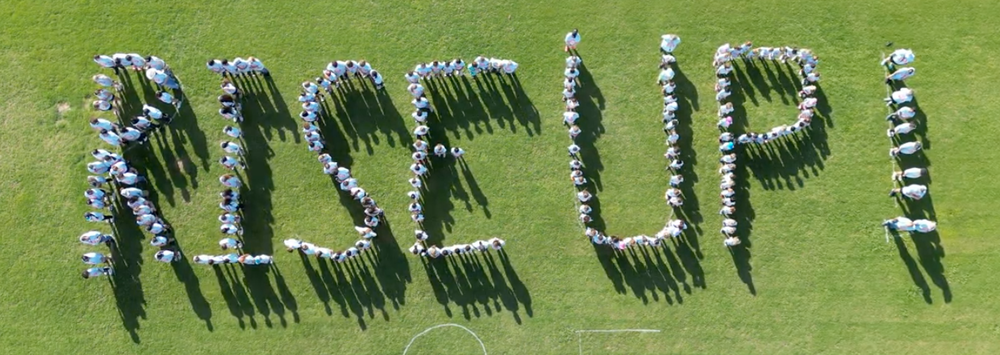 Rise Up (spelled out in people from 2025) aerial photo
