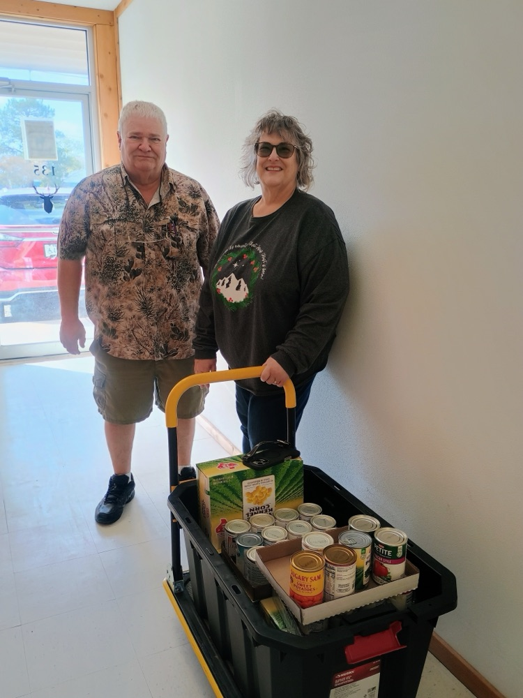 Sexton family donated food to the food pantry for distribution, image of food and couple