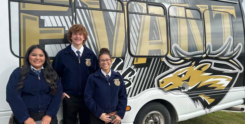 CDE image, 3 FFA students and the small trip bus
