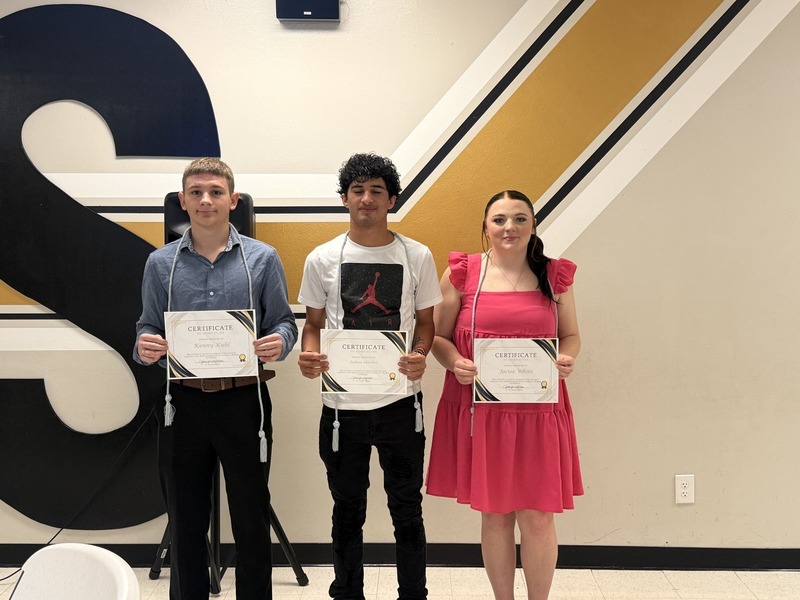 Kenny K, Joshua S, & Jociee W receive certificates and cords, image