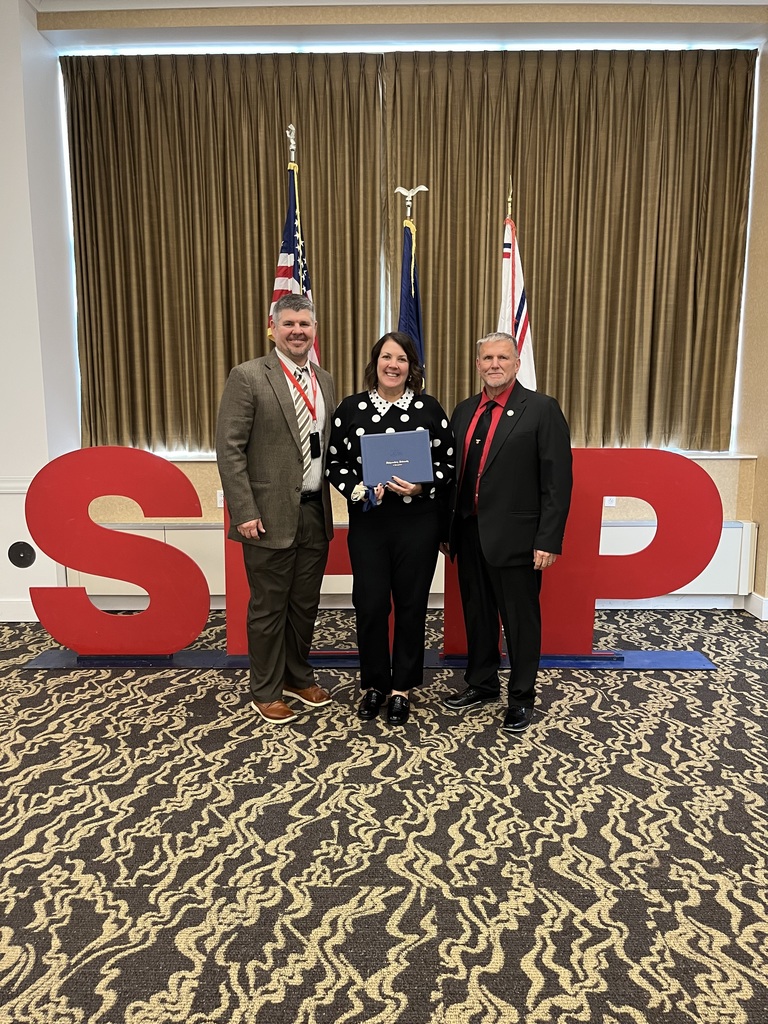 Nicole Hillegas, along with Justin Hillegas and Mr. David Burkett, stands with Nicole's nomination for 2025 outstanding teachers