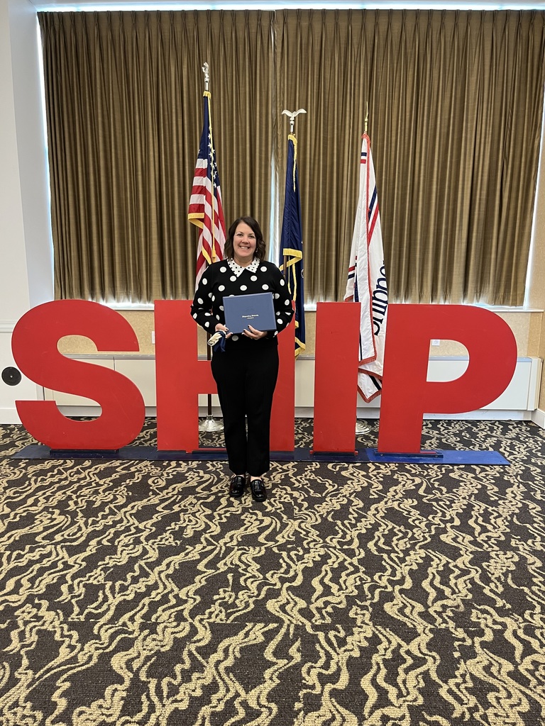 Nicole Hillegas stands with her nomination for 2025 outstanding teachers