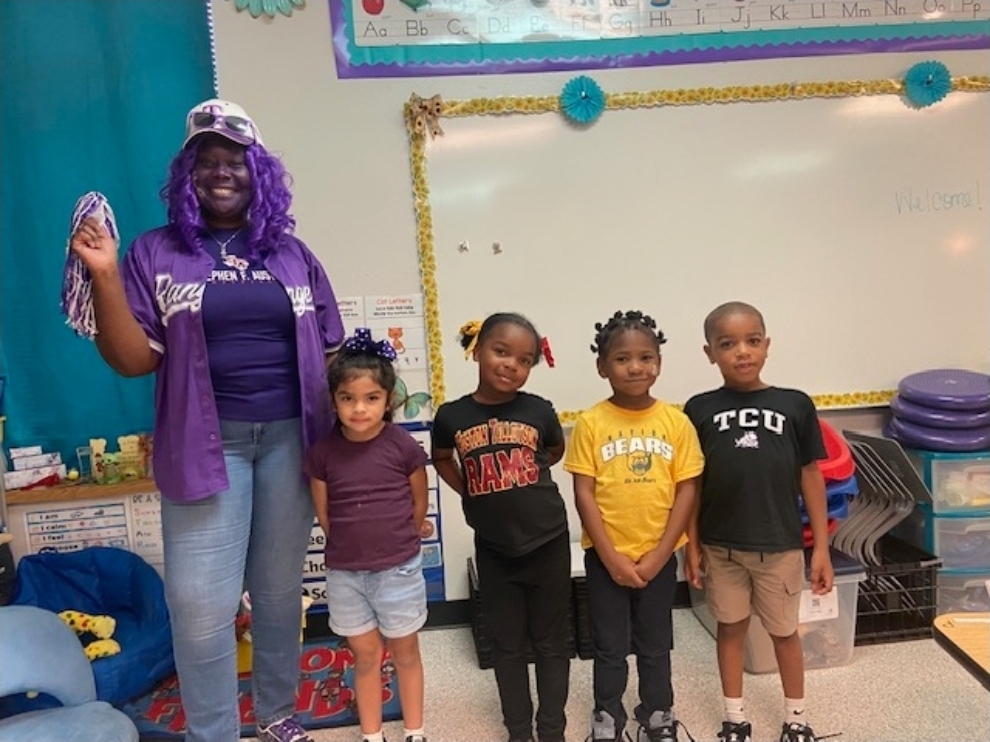 Mrs. Sanchez and students with college colors