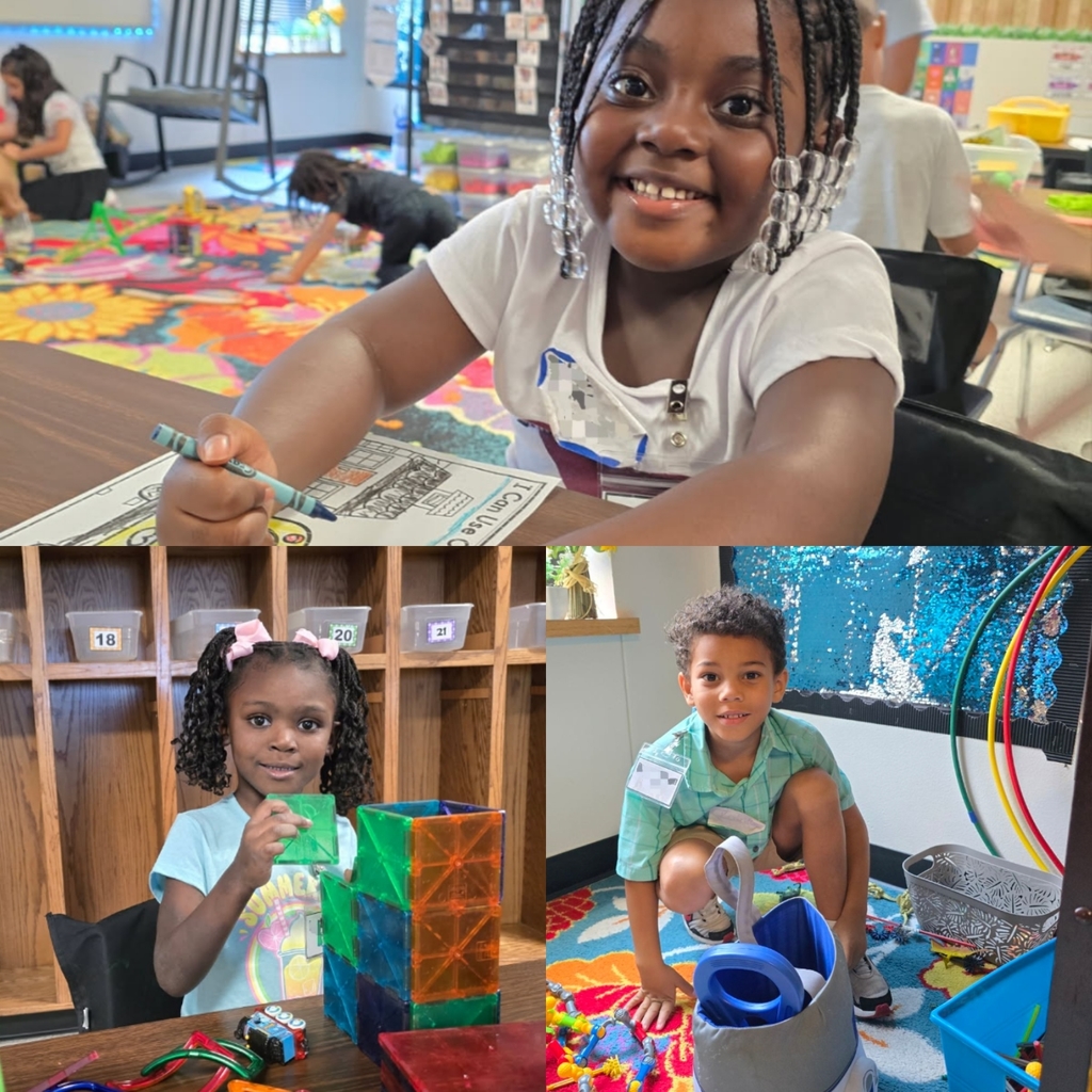 students working during centers, smiling at the camera