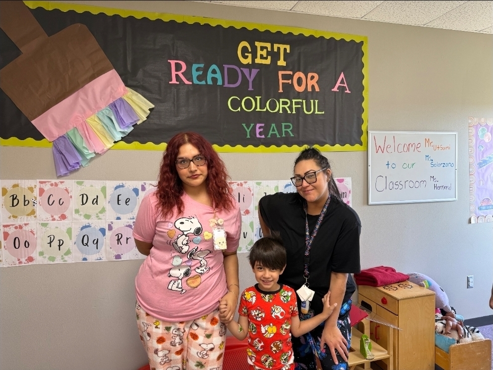 student posing with 2 teachers