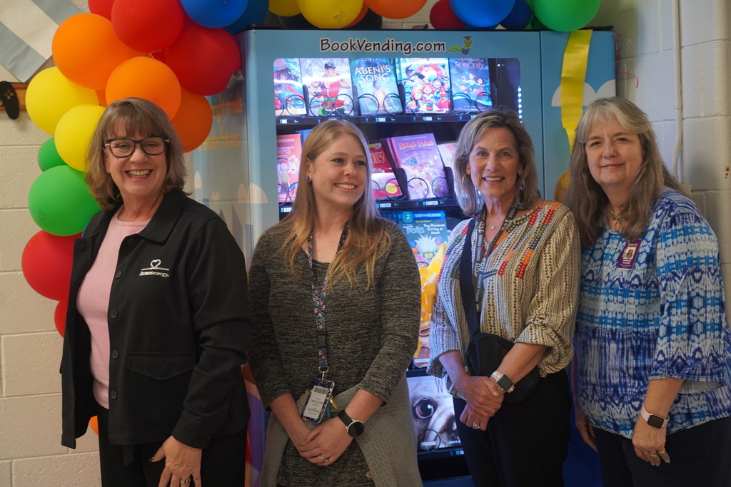 Adults in front of vending machine