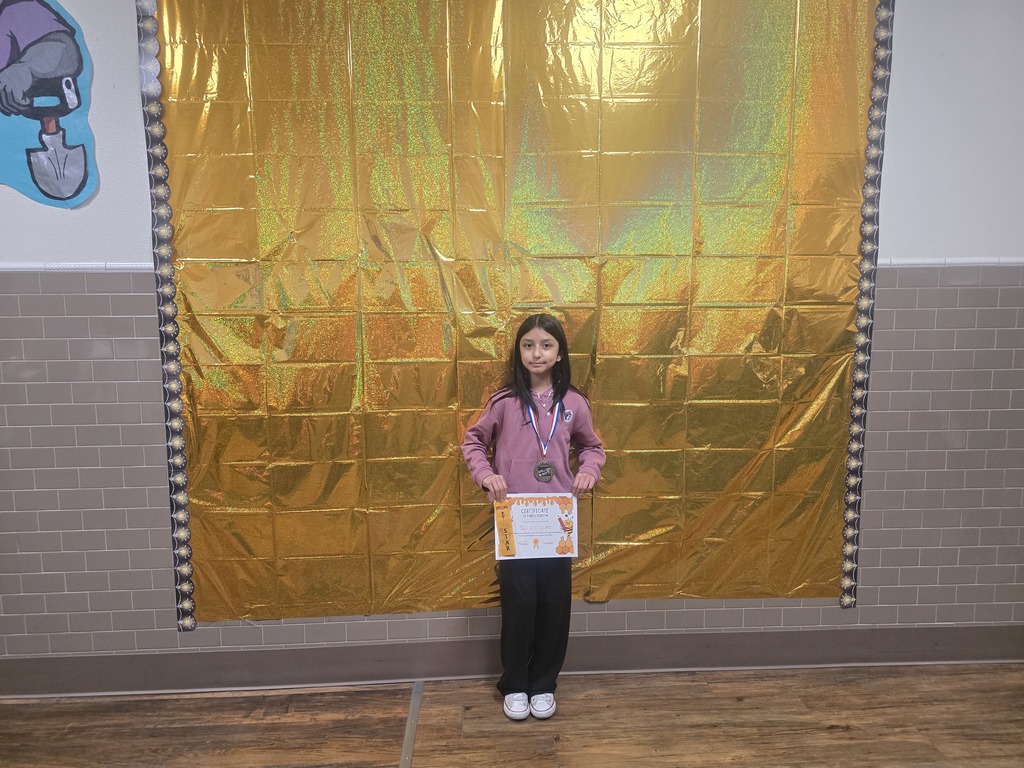 Spelling Bee winner 1st place Sol holding her certificate