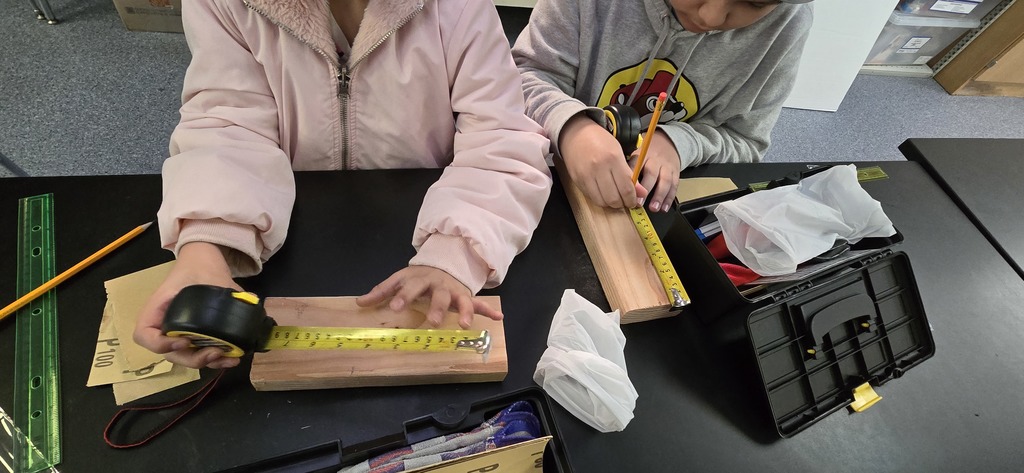 Hommel construction club reviewed the concepts of friction and grit for sanding, the reason we measure twice, and the amount of force needed to sink a nail. 