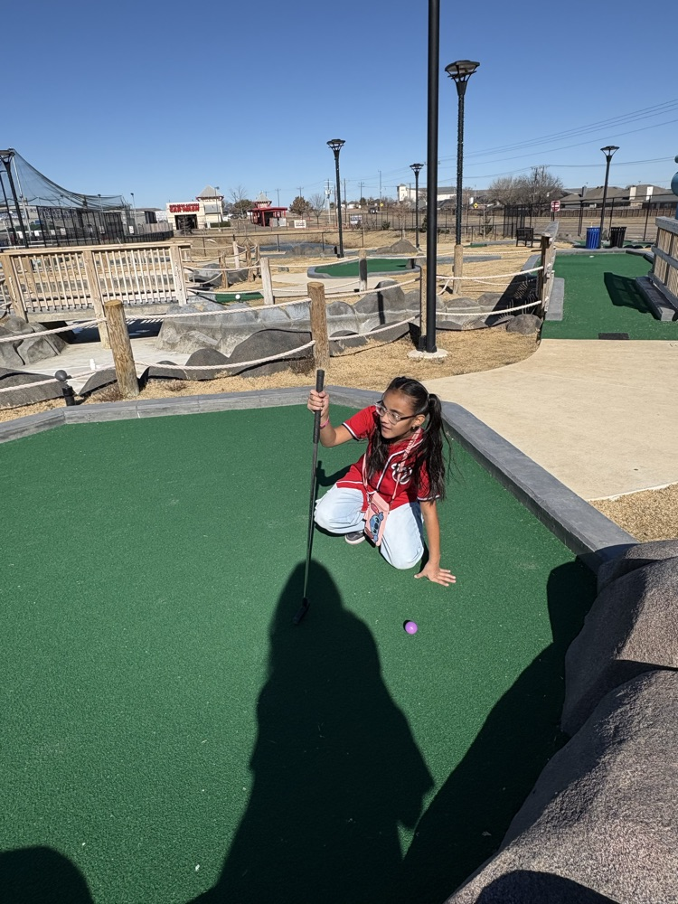 Students playing miniature golf