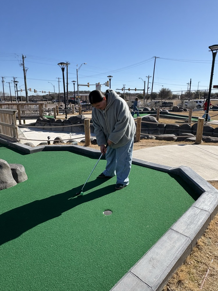 Students playing miniature golf