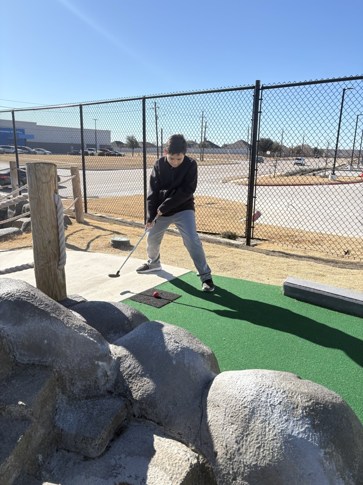 Students playing miniature golf