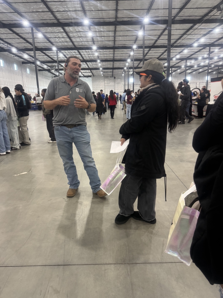 student talking to managers about available positions