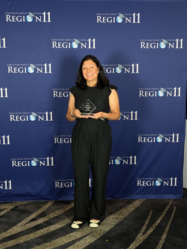 Mrs. Rayman holding her award.