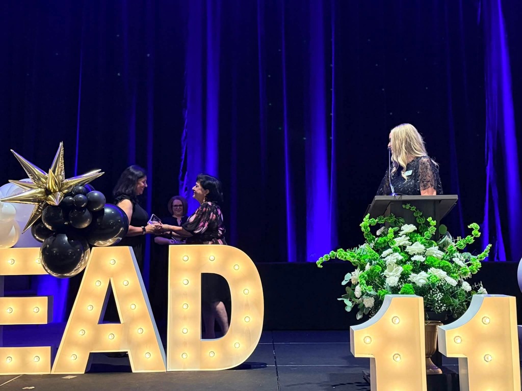 Mrs. Rayman receiving her award.