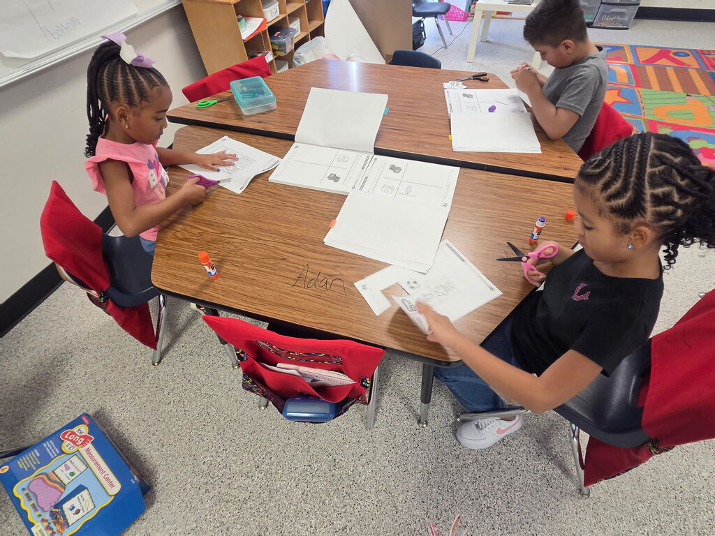 Students are cutting papers. 