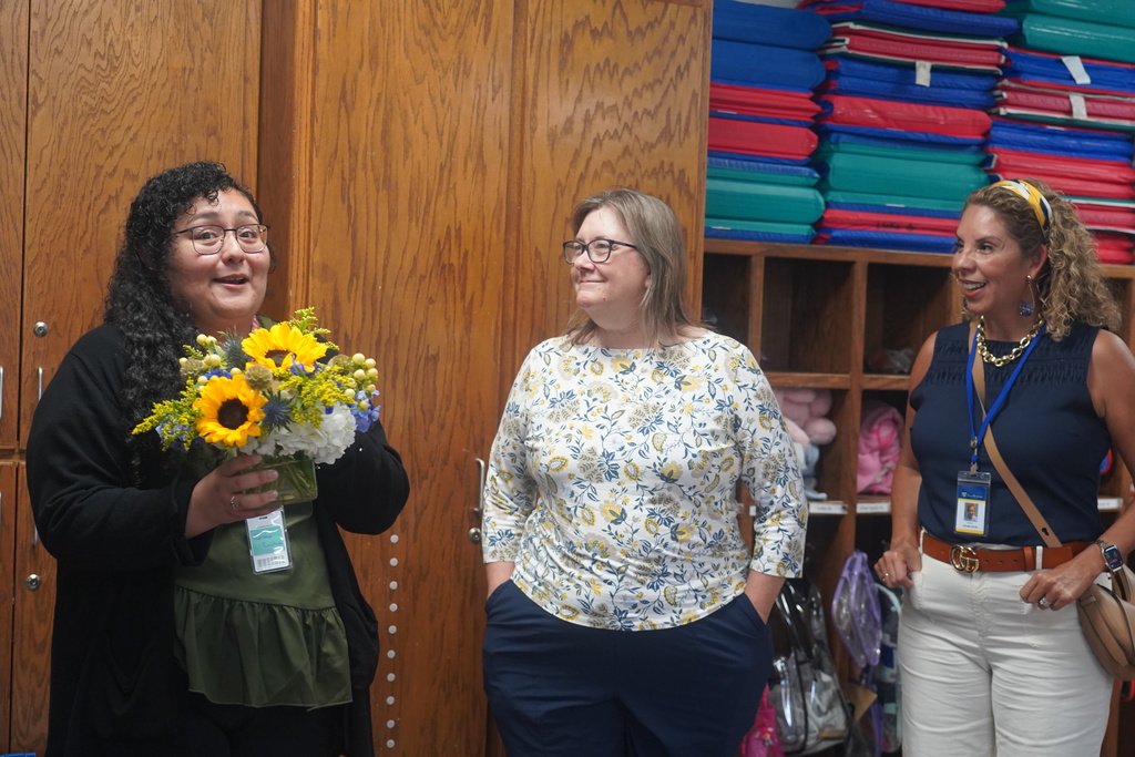 Everman ISD+ Adriana Escobedo receives her flowers for the directors, accepting her flowers  as a 2025-2026 Clinical Teacher of the Year recipient