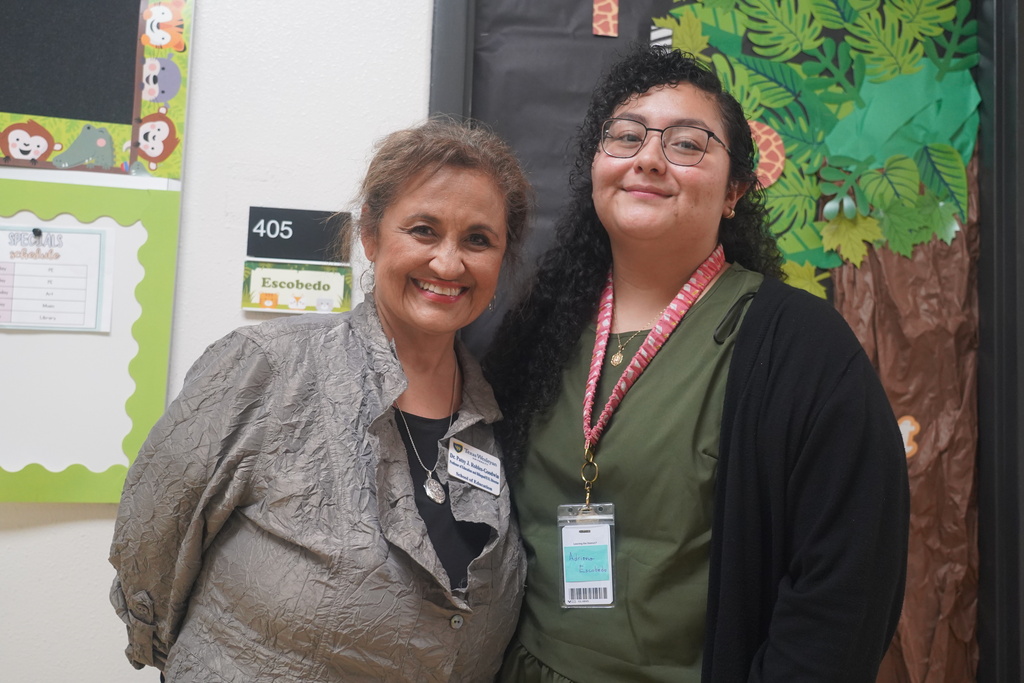 Everman ISD+Adriana Escobedo posing with her professor at TWU