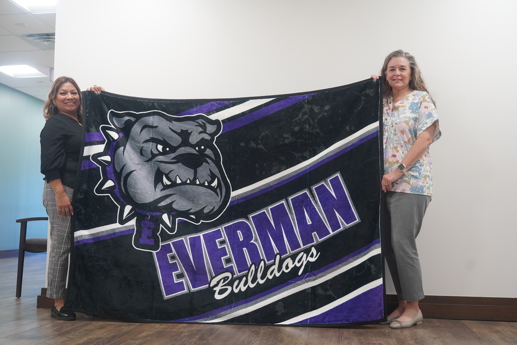 Everman ISD+Two Admin showing off how the blanket looks on each side 