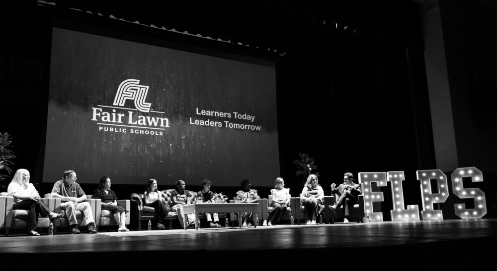 staff members on stage for a presentation