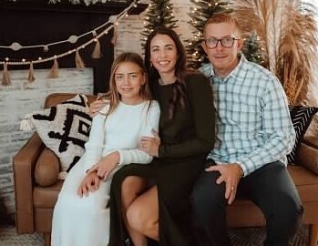 Basketball coach posing with her family
