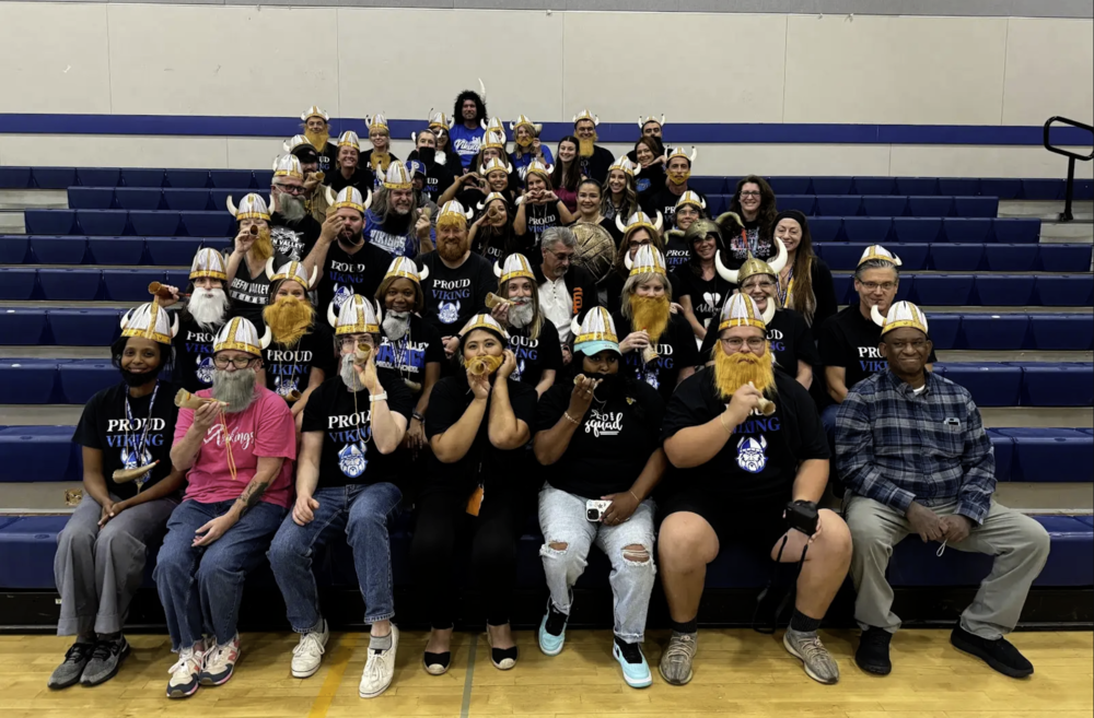 Staff from Green Valley Middle School dressed in mascot viking gear taking a photo