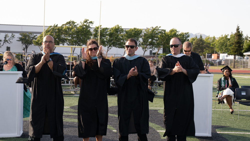 Group of RHS admin clapping at a graduation